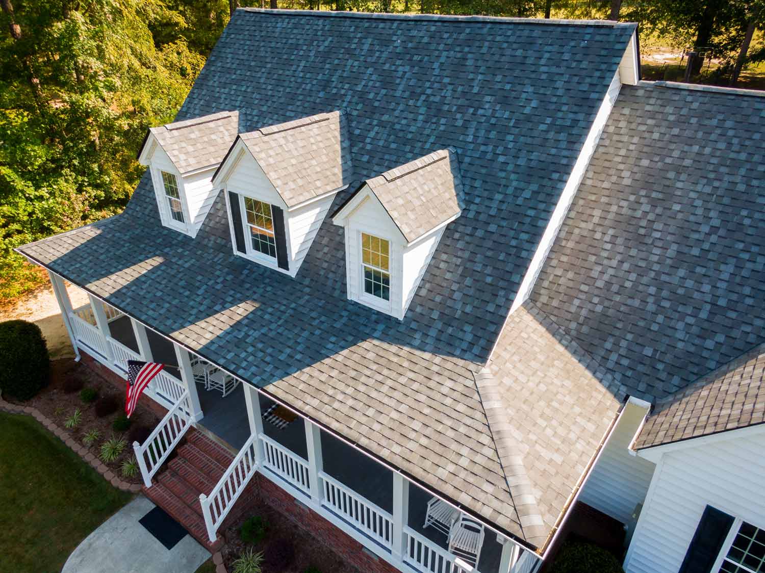 Close up aerial view of a home with brown asphalt shingles
