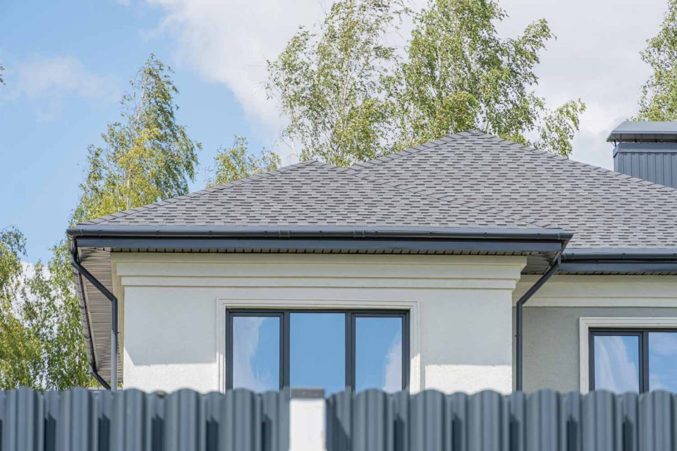 White home with gray asphalt shingles