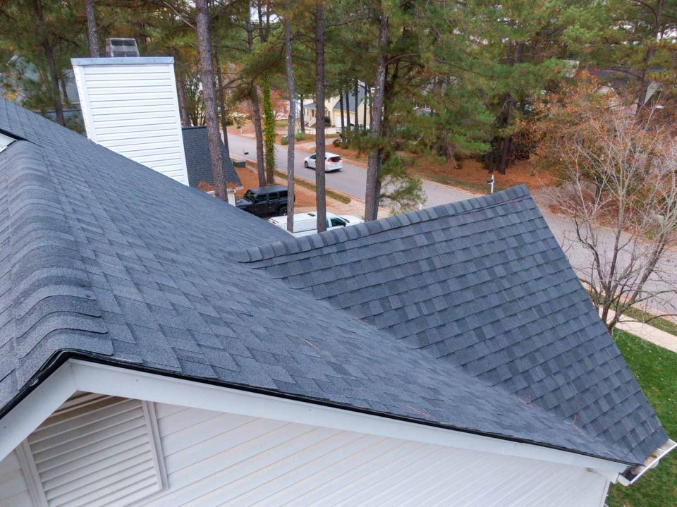 Close up aerial view of a home with dark gray asphalt shingles