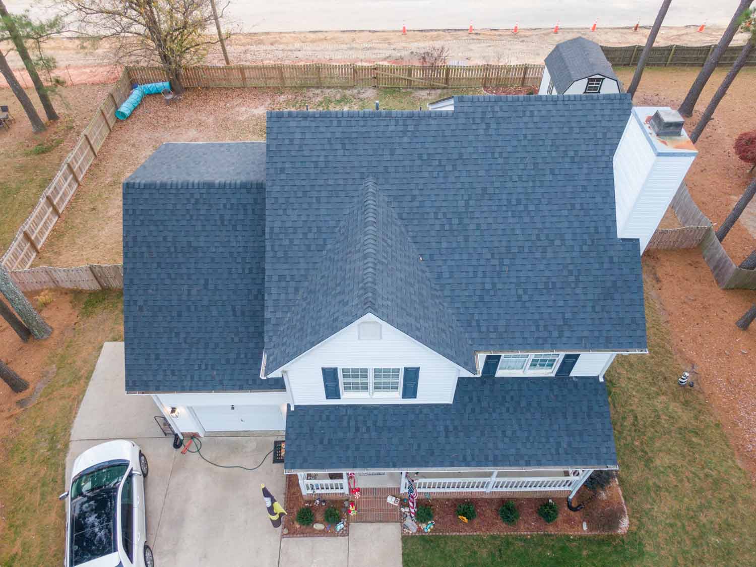 Aerial view of a 2 story white home with dark gray asphalt shingles