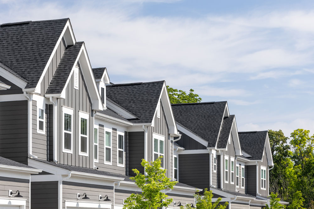 Row of townhomes with charcoal asphalt roofs